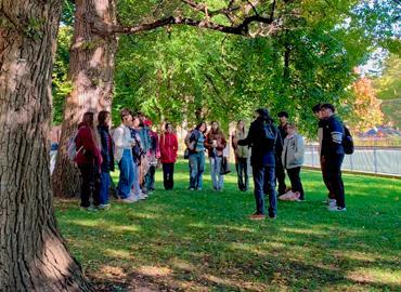 Alan Ackerman’s class stand outside under beautiful lush green elm trees.